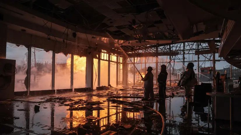 epa11053176 Firefighters work to extinguish a fire at a car dealership after a missile strike in Kyiv (Kiev), Ukraine, 02 January 2024, amid the Russian invasion. In the early hours of 02 January, Russia launched missile attacks targeting Kyiv and Kharkiv, local officials reported. At least two women were killed and nearly 70 others were injured in the two cities. In Kyiv, 27 people were hospitalized after a fire broke out in a multi-story building as a result of a rocket attack, the city mayor Vitali Klitschko wrote on telegram, adding that an injured elderly woman died in an ambulance. Some 130 residents were evacuated from the burning building, the State Emergency Service said. EPA/OLEG PETRASYUK