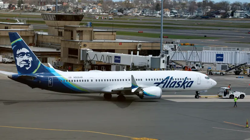 epa11285310 Crews reposition an Alaska Airlines aircraft on the apron at Logan International Airport in Boston, Massachusetts, USA, 17 April 2024. Alaska Airlines officials halted all flights for a short period of time following an issue with the software that calculates the weight and balance of the carrier's aircraft. EPA/CJ GUNTHER