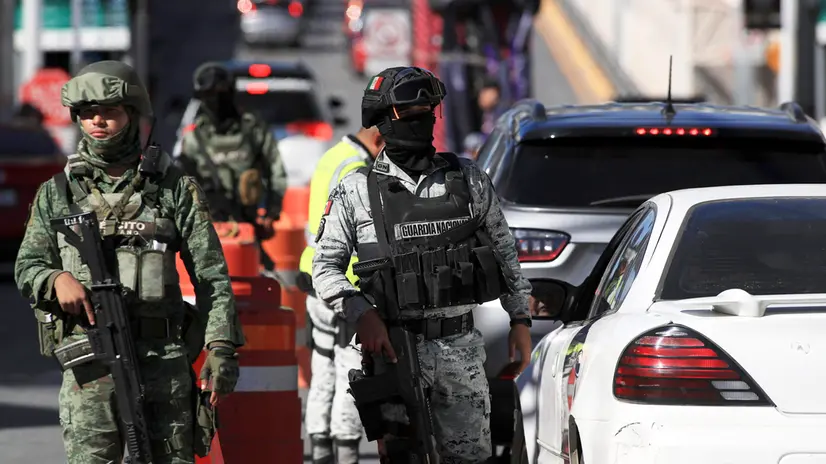 epa11881847 Members of the Mexican National Guard and the Army stand guard at Paso del Norte International Bridge in Ciudad Juarez, Mexico, 07 February 2025. As part of agreements between Mexico and the United States for the detection of fentanyl, National Guard and Army checkpoints have been deployed at international bridges to inspect people attempting to cross into US territory. EPA/Luis Torres