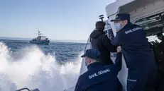 epa09131071 Members of the Turkish Coast Guard give a warning to a Greece Coast Guard ship, which allegedly crossed into Turkish waters, during a patrol to search and rescue for migrants as they pass to or pushed back from Lesvos Island of Greece offshore the Ayvalik district in Balikesir, Turkey, 10 April 2021 (issued 12 April 2012). The Greek island of Lesbos hosts one of the hotspots, an initial reception centers for migrants in European Union. Turkish authorities told epa/Efe that in 2020 around 45 percent of migrants rescued in the Aegean Sea had been pushed back from Greek territory. Most common cases involve migrant vessels being stopped by a Greek patrol when entering Greek waters, but the Turkish coastguard says it has heard lots of migrants describing 'delayed pushback,' when people are returned to the sea days after they reached Lesbos. According to Turkish officials, in this case, a Greek patrol carries the detained migrants to the limit of Greek territorial waters before putting them in a life raft and alerting Ankara. Since the beginning of 2021, Turkey has rescued around 2,700 migrants in the Aegean Sea, and some 1,900 migrants from a pushback. The Norwegian NGO Aegean Boat Report claims, some 558 people have been abandoned on 35 life rafts at sea so far in 2021. Some such incidents have ended with fatalities, the organizations claimed. EPA/ERDEM SAHIN ATTENTION: This Image is part of a PHOTO SET
