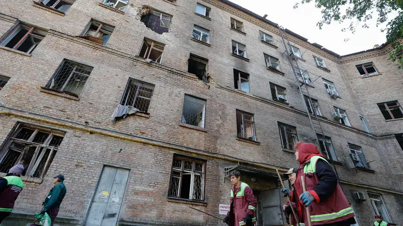 epa12472162 Communal workers walk past a damaged residential building after an overnight Russian strike in Kyiv, Ukraine, 22 October 2025, amid the ongoing Russian invasion. At least two people were killed and more than 20 others injured, including five children, after Russian strikes on Kyiv, the State Emergency Service of Ukraine reported. Across Ukraine, the attacks killed at least seven people, including two children, with regions including Kyiv, Odesa, Chernihiv, Dnipropetrovsk, Kirovohrad, Poltava, Vinnytsia, Zaporizhia, Cherkasy, and Sumy affected, according to President Zelensky. EPA/SERGEY DOLZHENKO