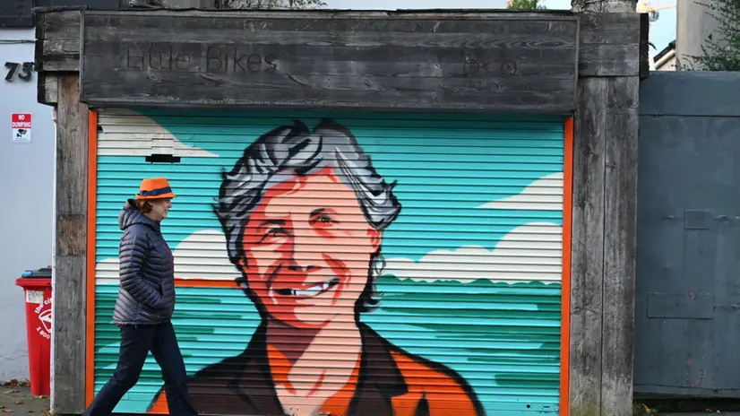 epa12478130 A person walks past a graffiti portrait of Irish presidential candidate Catherine Connolly during elections for the Irish president in Dublin, Ireland, 24 October 2025. The new president is due to take office on 12 November 2025. EPA/BRYAN MEADE