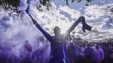 epa12435809 A supporter of Argentine President Javier Milei holds a flare before an event held by the president, in Buenos Aires, Argentina, 06 October 2025. Milei presented his new book, La Construcción del Milagro (The Making of the Miracle), at an event held in the midst of the campaign season for the national legislative elections scheduled for 26 October 2025. EPA/Juan Ignacio Roncoroni