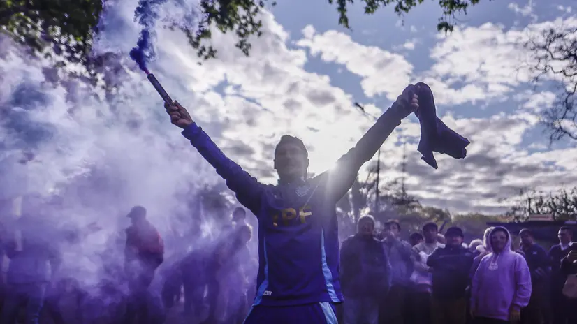 epa12435809 A supporter of Argentine President Javier Milei holds a flare before an event held by the president, in Buenos Aires, Argentina, 06 October 2025. Milei presented his new book, La Construcción del Milagro (The Making of the Miracle), at an event held in the midst of the campaign season for the national legislative elections scheduled for 26 October 2025. EPA/Juan Ignacio Roncoroni