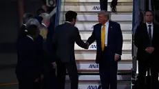 epa12485322 US President Donald Trump (C-R) is welcomed by Japan's newly appointed Chief Cabinet Secretary Minoru Kihara (C-L) upon arrival at Haneda International Airport in Tokyo, Japan, 27 October 2025.The president is on a three-day visit that includes meetings with Japan's newly elected Prime Minister Sanae Takaichi and Emperor Naruhito, aimed at reaffirming the Japan–US alliance. EPA/DAVID MAREUIL / POOL