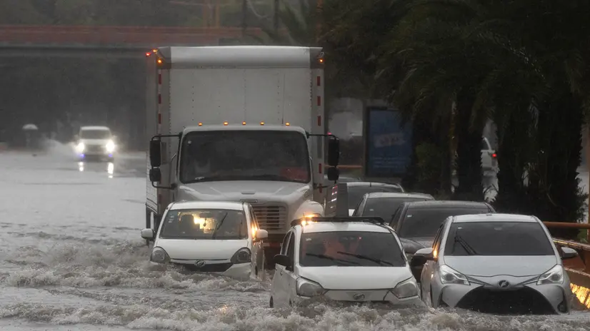 epa12477319 Vehicles drive down a flooded street in Santo Domingo, Dominican Republic, 23 October 2025. More than 647,000 users are without drinking water in the Dominican Republic after rains from Tropical Storm Melissa affected dozens of aqueducts, according to official data. EPA/Orlando Barria