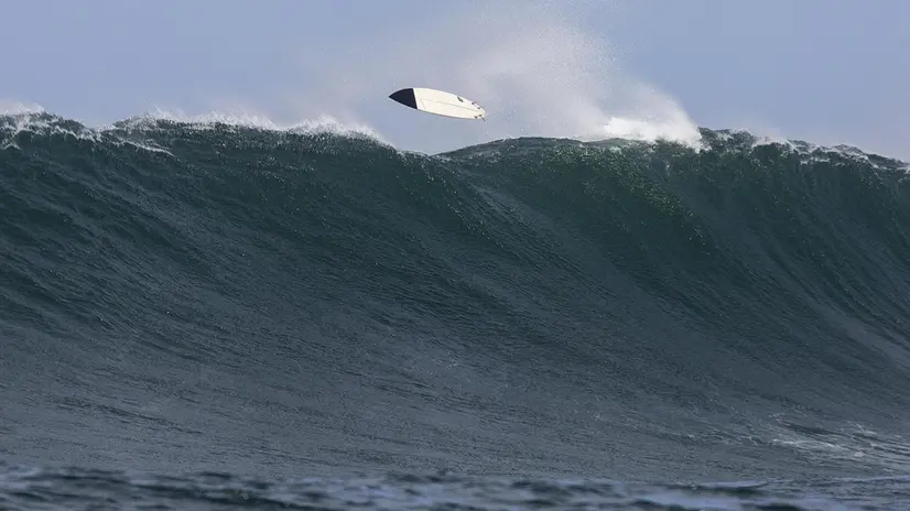 epaselect epa07283131 A surfboard flys over the back of a wave as the rider swims under it at Dungeons offshore reef in the Atlantic Ocean outside Cape Town, South Africa, 14 January 2019. Storms in the South Atlantic generated powerful swells measuring five meters with a fifteen second period that broke on the Cape's outer reefs. EPA/NIC BOTHMA
