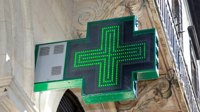 green cross Pharmacy sign in street building store