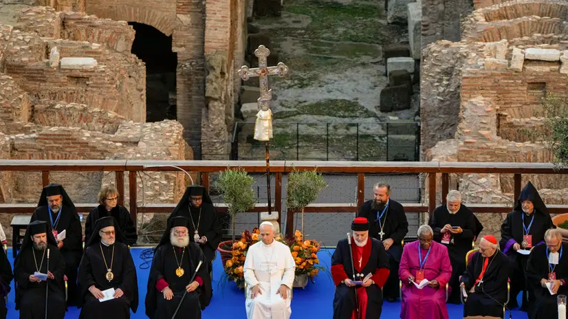 Pope Leo XIV, center, attends an inter-religious meeting with, front row from left, Archbishop of Tirana Durres and All Albania John, Armenian Patriarch of Constantinople Archbishop Sahag II Mashalian, Patriarch Theodore II of Alexandria, Catholicos-Patriarch of the Assyrian Church of the East Mar Awa III, Anglican archbishop of Cape Town Thabo Makgoba, Cardinal Louis Rapahel Sako, and President of the Lutheran World Federation Henrik Stubkjær to pray for peace inside the Colosseum in Rome, Tuesday, Oct. 28, 2025. (AP Photo/Gregorio Borgia)