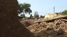 epa10135169 Damaged houses at a flooded area of Al Jazirah state, Sudan, 23 August 2022. According to the Sudanese Council for Civil Defense, at least 79 people died in incidents related to the recent floods in the country. Thousands of homes were damaged due to the floods that affected South Darfur, North Kordofan, and Al Jazirah state. EPA/MOHND AWAD