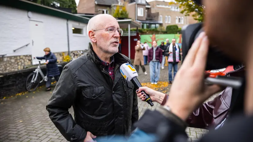 epa12489575 GreenLeft/Labour Party (GroenLinks/PvdA) leader Frans Timmermans (L) speaks to the press after casting his vote for the House of Representatives elections at the Sint Pieter community center in Maastricht, Netherlands, 29 October 2025. EPA/ROB ENGELAAR