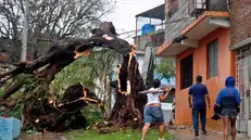 epa12490836 People walk along a street affected by Hurricane Melissa in Santiago de Cuba, Cuba, 29 October 2025. Melissa is moving away from Cuba as a Category 2 hurricane, with maximum sustained winds of up to 160 kilometers per hour, and is beginning to head toward the Bahamas after causing flooding, river overflows, and landslides in eastern Cuba. EPA/Ernesto Mastrascusa