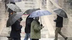 epa07206124 People walk with umbrellas during rain and polluted air, in Sarajevo, Bosnia and Herzegovina, 03 December 2018. It is recommended that Sarajevo residents reduce traffic in the streets and reduce traffic. With 180 AQI (Air Quality Index), Sarajevo today is one of the most polluted cities in the world, according to the data of the US Embassy in Sarajevo. EPA/FEHIM DEMIR