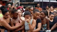 epa12490866 People cry on a street where dead bodies are gathered in Rio de Janeiro, Brazil, 29 October 2025. The police operation launched on 28 October in Rio de Janeiro, the deadliest in the Brazilian city's history, left more than 100 people dead, including four officers, according to the Public Defender's Office. EPA/ANTONIO LACERDA WARNING EDITORS: EXPLICIT GRAPHIC CONTENT