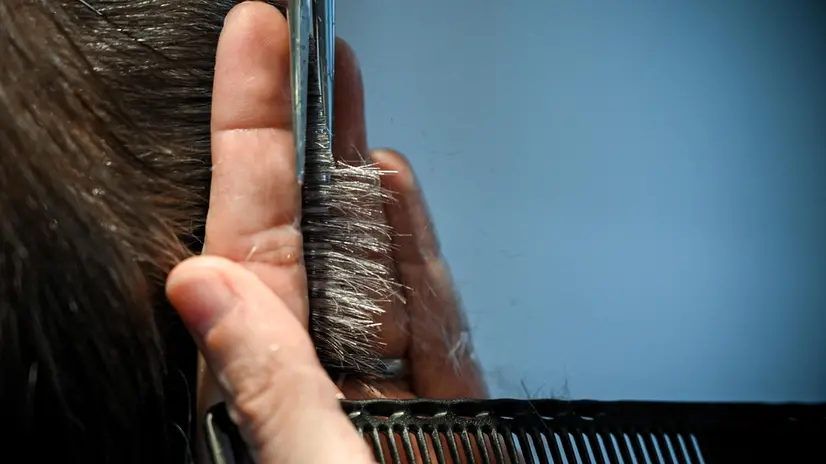 epa09045294 Owner Rene Hartig of 'Capelli Connection - Hartig & Messina' serves a client in his hair salon in Duisburg, Germany, 01 March 2021. Hairdressers are allowed to reopen from 01 March 2021 under strict conditions. Hair salons have been closed since mid-December due to the corona pandemic, and they had to shut down once before in the spring of 2020. In the meantime, the businesses were only allowed to open under strict conditions - this time, too, the preparations are based on a strict hygiene concept. After three months of closure, Hartig and his hairdresser colleagues are fully booked until the end of April. EPA/SASCHA STEINBACH