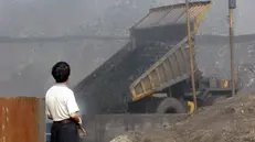 epa03086904 (FILE) A file photo dated 07 July 2005 showing a worker watching a large earth mover dumping coal down into a collection pit at the Antaibao open-air coal mine near Shuozhou, Shanxi Province, China. Geneva-based World Trade Organization (WTO) dismissed a Chinese appeal on 30 January 2012 and upheld its decision that Beijing’s practice of limiting certain raw materials including magnesium should end. Western countries that won the trade dispute over Chinese export restrictions on industrial raw materials, have already set their sights on a new goal: prying open Beijing's restrictive policies on rare earths. However, China is unlikely to budge on these minerals, now sought after by high-tech industries, unless there is a specific new ruling by the World Trade Organization (WTO), expert Jaakko Kooroshy said 31 January 2012. EPA/QILAI SHEN