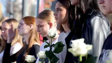 epa12496982 People observe 16 minutes of silence as they pay respect to the victims in front of the Novi Sad train station during the commemoration in Novi Sad, Serbia, 01 November 2025. The student-led event marks the first anniversary of the railway station canopy collapse that killed 16 people, sparking widespread protests demanding political accountability. EPA/ANDREJ CUKIC