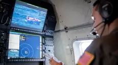 epa10263806 US Coast Guard radar operator Leonardo Nieves checks the images of a raft full of people during his patrol and law Enforcement flight over the Florida Straits aboard of a HC-144 Medium Range Surveillance Aircraft, departed from the US Coast Guard Air Station Miami in Miami, Florida, USA, 24 October 2022. According to the US Government, the Homeland Security Task Force enhanced its operational posture and readiness to address a recent increase in irregular maritime migration originating from the Bahamas and Cuba through the Florida Straits, from Haiti through the Windward Pass, and from the Dominican Republic to Puerto Rico through the Mona Pass. EPA/CRISTOBAL HERRERA-ULASHKEVICH