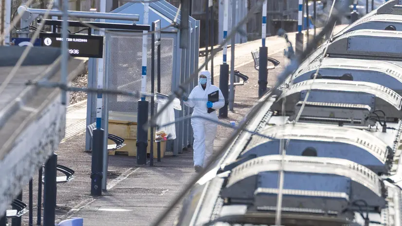 epa12498846 Forensic teams work at the scene at Huntington railway station, where a London-bound train stopped after several people were stabbed in Huntington, Britain, 02 November 2025. Multiple people were stabbed on a train going from Doncaster to London. Ten people were initially taken to hospital; two people remain in a life-threatening condition. Two British nationals have been taken into custody in connection with the incident, according to police. EPA/TAYFUN SALCI