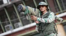 epaselect epa12494376 A member of Venezuela's Bolivarian Militia stands guard during a pro-government demonstration in Caracas, Venezuela, 30 October 2025. Supporters of President Nicolas Maduro marched against the US military deployment in the Caribbean Sea, which Washington says targets drug trafficking. Maduro claims the mission is a cover to remove him from power. EPA/RONALD PENA R