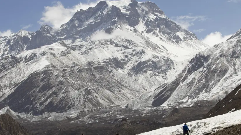 epa04696848 A picture made available on 09 April shows domestic tourists enjoying snow with the Mt. Dhaulagiri, 8,167 meters tall and 7th-highest mountain in the world, on the background at Muktinaath at an altitude of 3800 meters in Mustang district, north east of Nepal, 05 April 2015. Mustang is the former kingdom of Lo, Nepal, located near to Tibet, China. People of Mustang are preserving the region's ancient culture, traditions and customs. Mustang is the second most popular tourist destination in Nepal after the Mt. Everest region. EPA/NARENDRA SHRESTHA