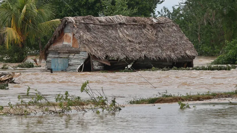 epa12496229 A house is flooded by a rising river in Cauto Cristo, Cuba, 31 October 2025. Cuba continues evacuating victims two days after Hurricane Melissa struck. EPA/Ernesto Mastrascusa