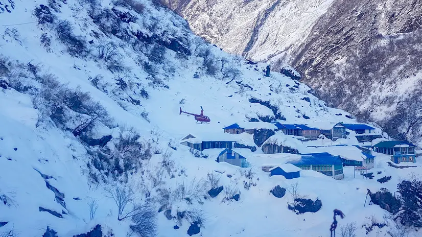 epa08144093 A rescue helicopter flies over Deurali village, near the avalanche site in Annapurna mountain region, Nepal, 20 January 2020. At least 6 people including four South Korean trekkers have been missing after an avalanche on route on Annapurna Mountain. EPA/ANG TASHI SHERPA