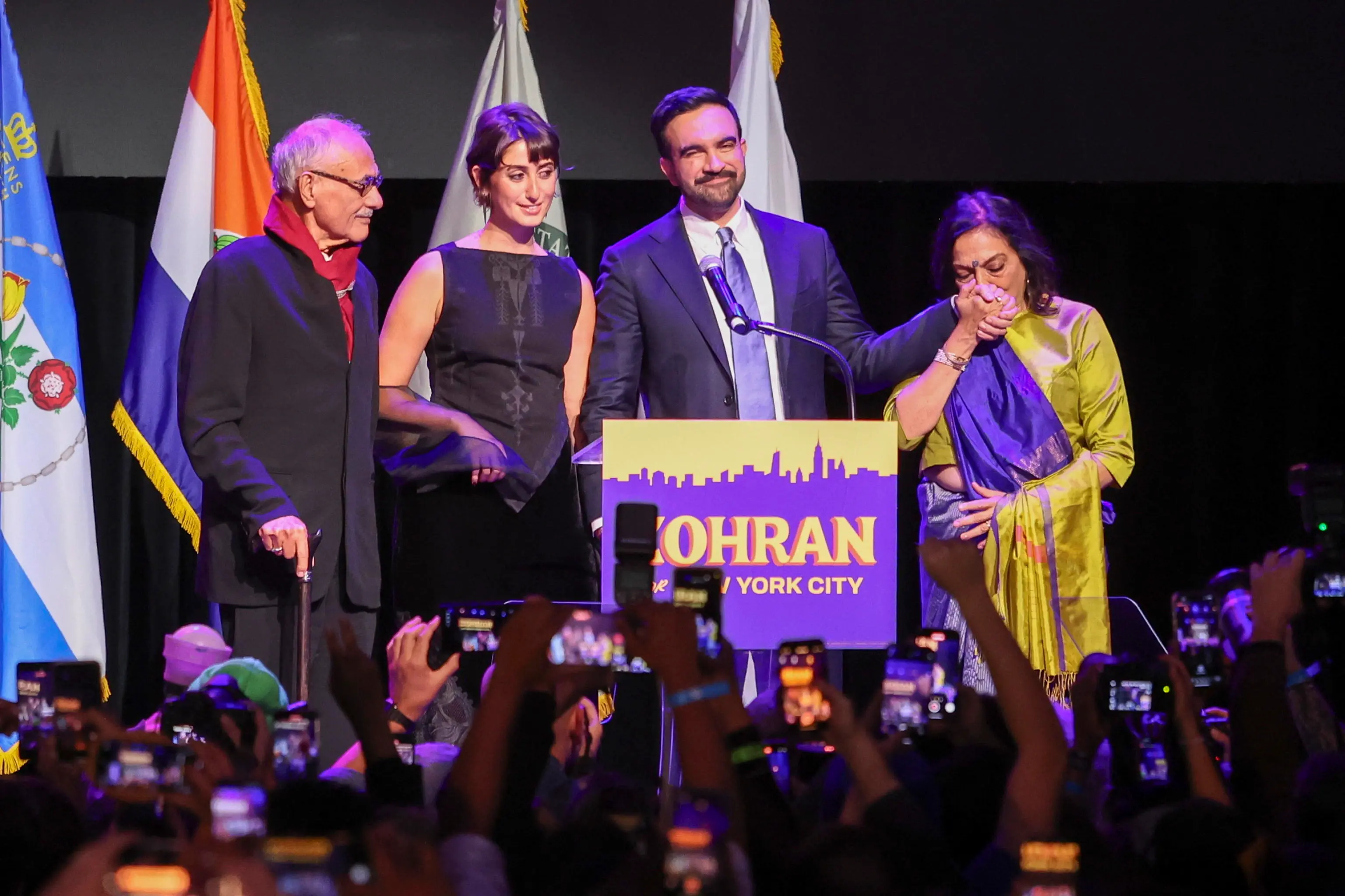 epa12504033 Mayor elect of New York City Zohran Mamdani (2-R), his father Mahmood Mamdani (L), spouse Rama Duwaji )2-L), and mother Mira Nair take the stage during an election night party hosted by the Democratic nominee in the Brooklyn borough of New York, USA, 04 November 2025. Mamdani has defeated Andrew Cuomo to win the New York mayoral election. EPA/SARAH YENESEL