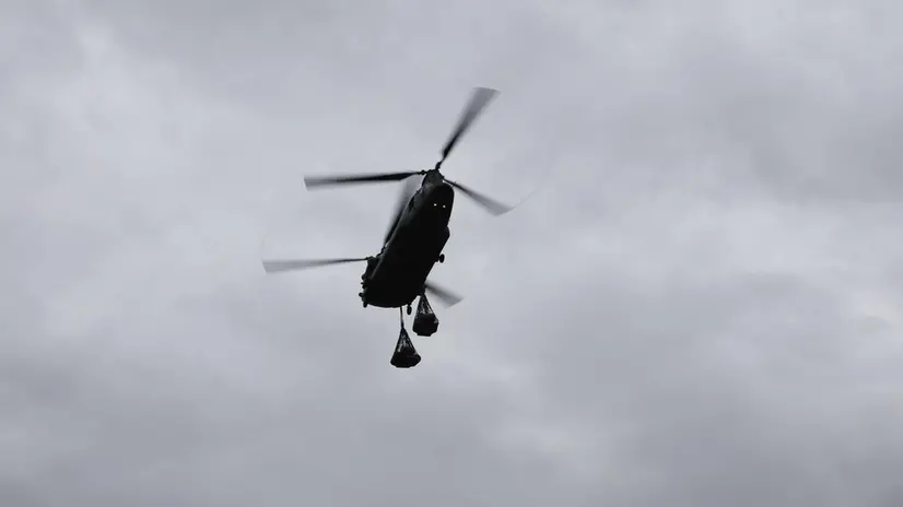 epa12299616 An Indian Air Force Chinook helicopter carries relief materials during the rescue mission at Harshil after the cloudburst in Dharali village in Uttarkashi district, Uttarakhand state, northern India, 14 August 2025. Indian authorities confirmed that more than 1,200 people had been rescued in several areas of the Himalayas after a powerful cloudburst struck the Dharali area in the Uttarkashi district on 05 August, triggering flash floods that swept away a village and left several people dead. EPA/RAJAT GUPTA
