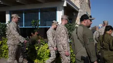 epa12469841 US soldiers, joined by Israeli officers, walk at Kibbutz Kfar Aza, near the border with Gaza in sourthern Israel, 21 October 2025. EPA/ATEF SAFADI
