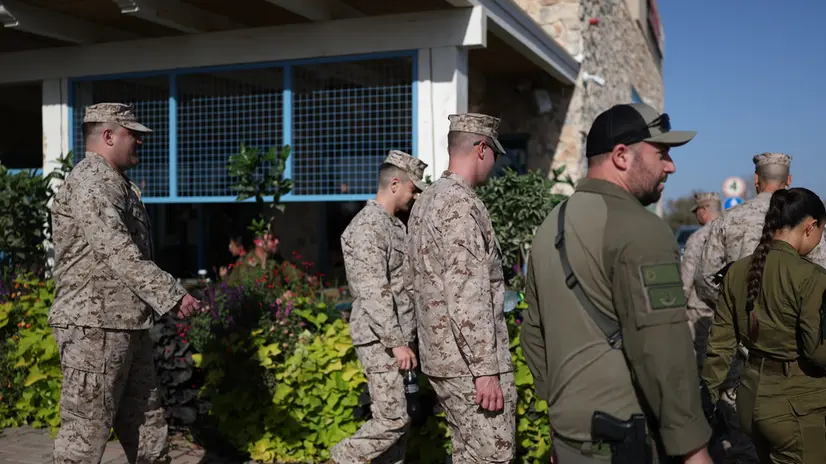 epa12469841 US soldiers, joined by Israeli officers, walk at Kibbutz Kfar Aza, near the border with Gaza in sourthern Israel, 21 October 2025. EPA/ATEF SAFADI