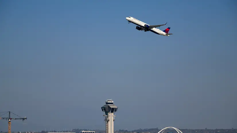 epa12509615 A Delta airplane takes off over the air traffic control tower at Los Angeles International Airport (LAX) in Los Angeles, California, USA, 06 November 2025. US Transportation Secretary Sean Duffy announced in a news conference that there will be a 10 percent reduction in flights at 40 major US airports on 07 November 2025 due to the impacts of the ongoing federal government shutdown. EPA/ALLISON DINNER