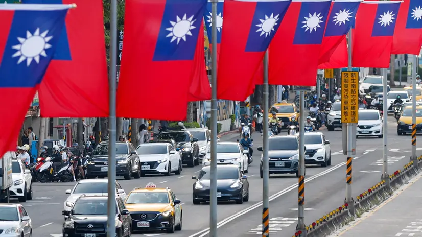 epa12426996 People drive past Taiwan flag installations ahead of National Day celebrations in Taipei, Taiwan, 03 October 2025. Taiwan's National Day will be celebrated on 10 October 2025. EPA/RITCHIE B. TONGO