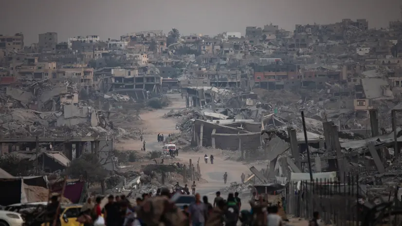 epa12505692 Displaced Palestinians sit next to their destroyed homes in Khan Yunis camp in the southern Gaza Strip, 05 November 2025. According to the UN around 90 percent of the population or 1.9 million people in Gaza have been displaced since the start of the conflict. EPA/HAITHAM IMAD