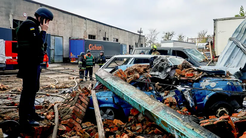 epa12478573 Ukrainian rescuers and policemen work at the site of a Russian glide bombs strike in Kharkiv, northeastern Ukraine, 24 October 2025, amid the ongoing Russian invasion. At least 8 people were injured after Russian strikes on the Industrial district in Kharkiv, according to the head of the Kharkiv Military Administration, Oleg Synegubov. EPA/SERGEY KOZLOV