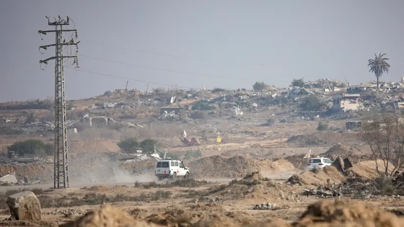 epaselect epa12514222 Red Cross vehicles transport a body after it was released by the al-Qassam Brigades, the military wing of Hamas, in Deir Al-Balah, central Gaza Strip, 09 November 2025. Hamas claims the body belongs to Israeli soldier Hadar Goldin, who was killed in the 2014 Gaza War. Israel has not yet positively verified the remains. EPA/HAITHAM IMAD