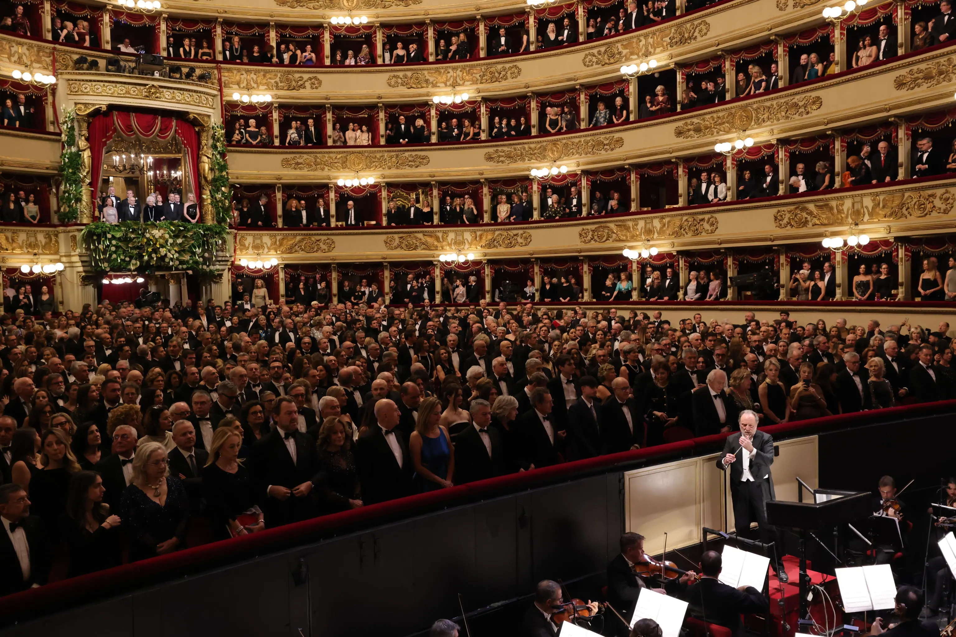 A photo released by the Teatro alla Scala press office shows the audience's applause for Senator for Life Liliana Segre as she entered the theater's main box, which opens this year's opera season with "A Lady Macbeth in the Mtsensk District," conducted by Riccardo Chailly, on his twelfth and final December 7 as the theater's music director. Milan, December 7, 2025. TEATRO ALLA SCALA HANDOUT +++ ANSA PROVIDES ACCESS TO THIS HANDOUT PHOTO TO BE USED SOLELY TO ILLUSTRATE NEWS REPORTING OR COMMENTARY ON THE FACTS OR EVENTS DEPICTED IN THIS IMAGE - NO ARCHIVING - NO LICENSING - NPK +++