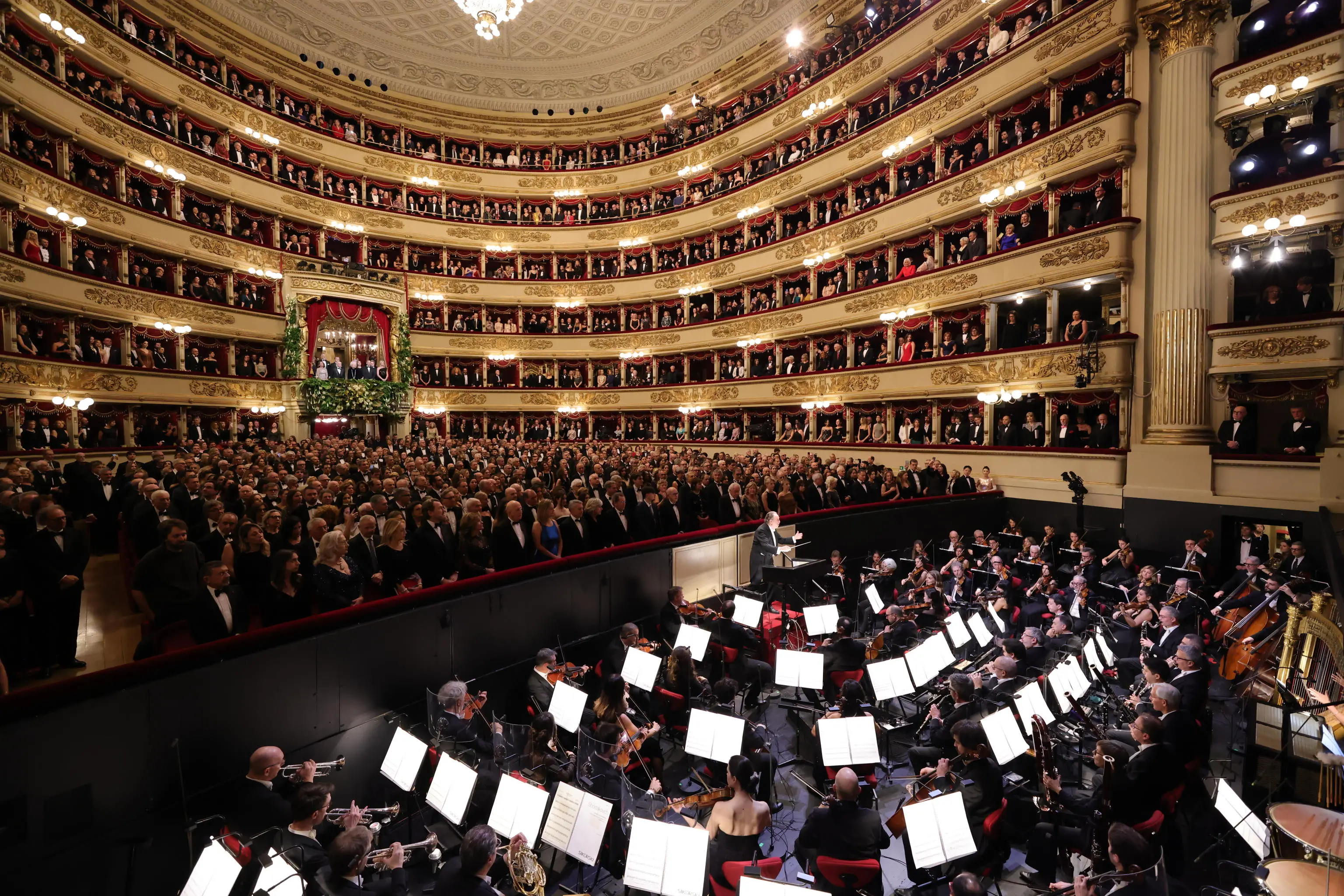 A photo released by the Teatro alla Scala press office shows the audience's applause for Senator for Life Liliana Segre as she entered the theater's main box, which opens this year's opera season with "A Lady Macbeth in the Mtsensk District," conducted by Riccardo Chailly, on his twelfth and final December 7 as the theater's music director. Milan, December 7, 2025. TEATRO ALLA SCALA HANDOUT +++ ANSA PROVIDES ACCESS TO THIS HANDOUT PHOTO TO BE USED SOLELY TO ILLUSTRATE NEWS REPORTING OR COMMENTARY ON THE FACTS OR EVENTS DEPICTED IN THIS IMAGE - NO ARCHIVING - NO LICENSING - NPK +++