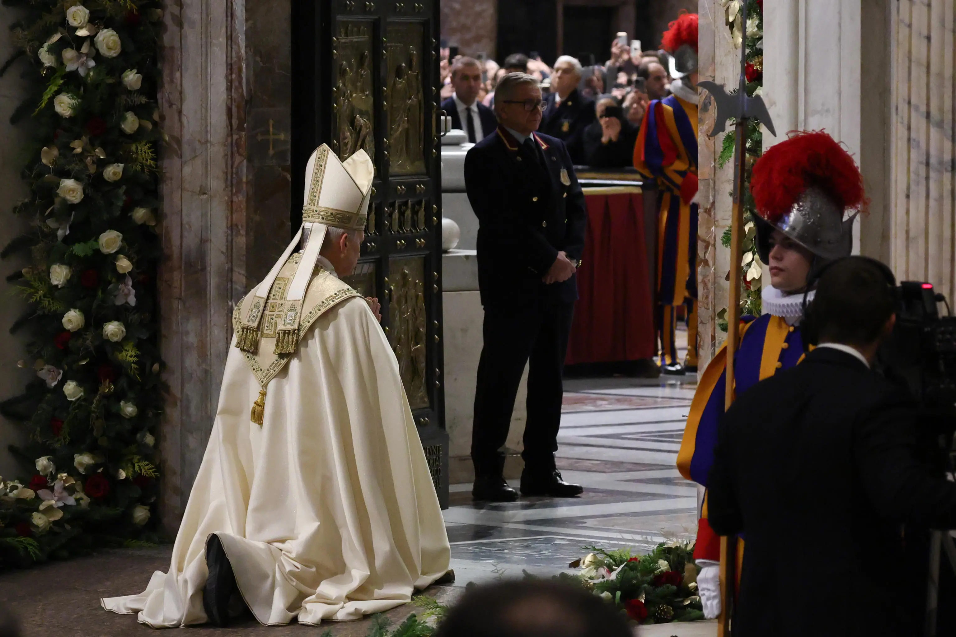 Pope Leo XIV kneels in front of the Holy Door of St. Peter’s Basilica on the Feast of the Epiphany, marking the official end of the Jubilee Year 2025, at the Vatican, January 6, 2026. REUTERS/Yara Nardi/Pool