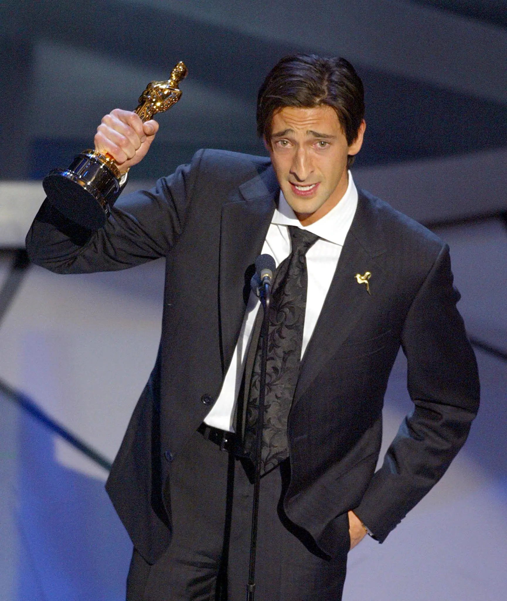 Actor Adrien Brody accepts his Oscar for Performance by an actor in a leading role in "The Pianist," during the 75th Academy Awards at the Kodak Theatre in Hollywood, California, 23 March, 2003. AFP PHOTO TIMOTHY A. CLARY