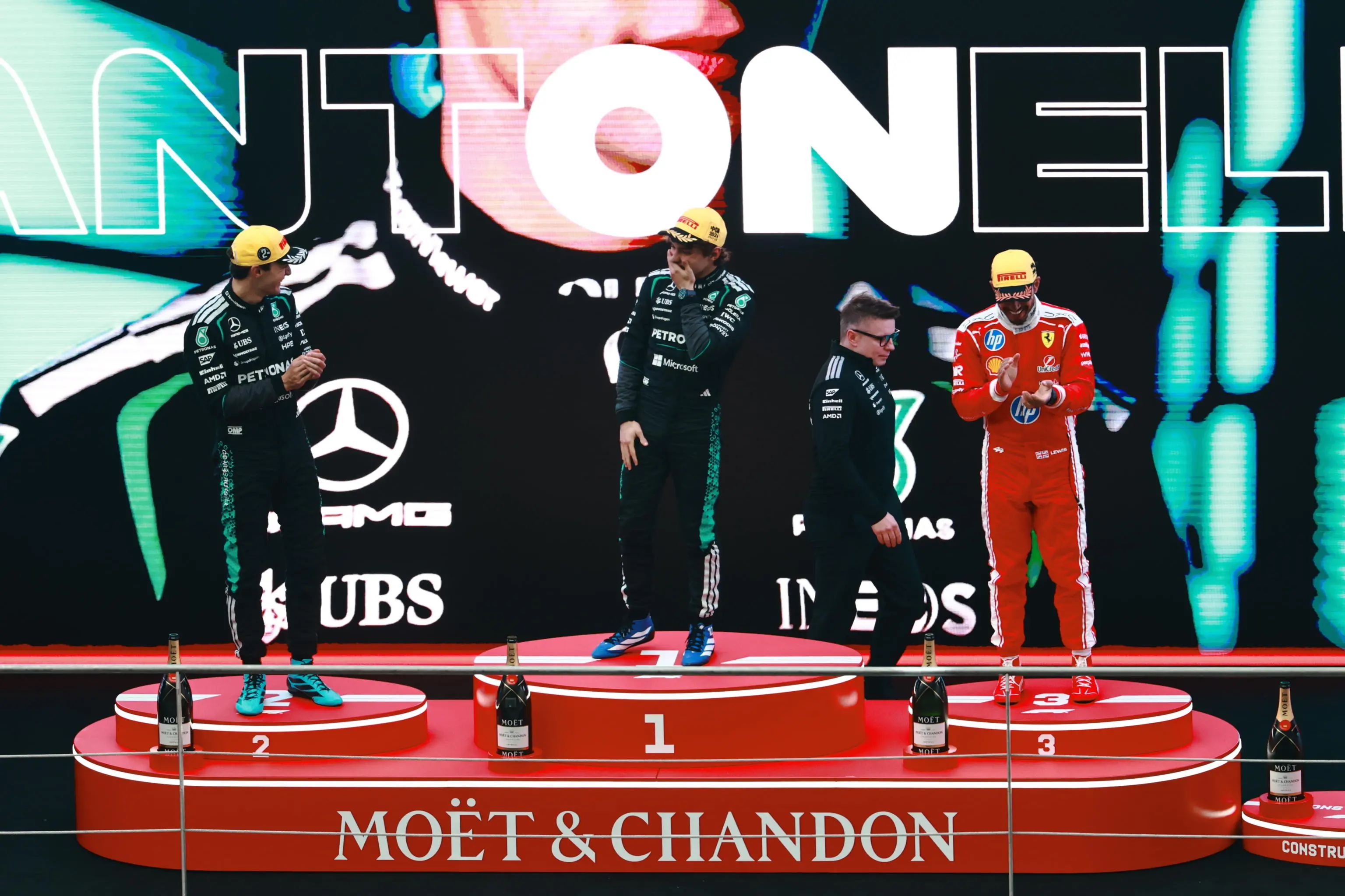 epa12820895 Winner Mercedes driver Andrea Kimi Antonelli (C) of Italy, second placed Mercedes driver George Russell (L) of Britain and third placed Scuderia Ferrari driver Lewis Hamilton of Britain pose on the podium after the 2026 Formula 1 Chinese Grand Prix, in Shanghai, China, 15 March 2026. EPA/ALEX PLAVEVSKI