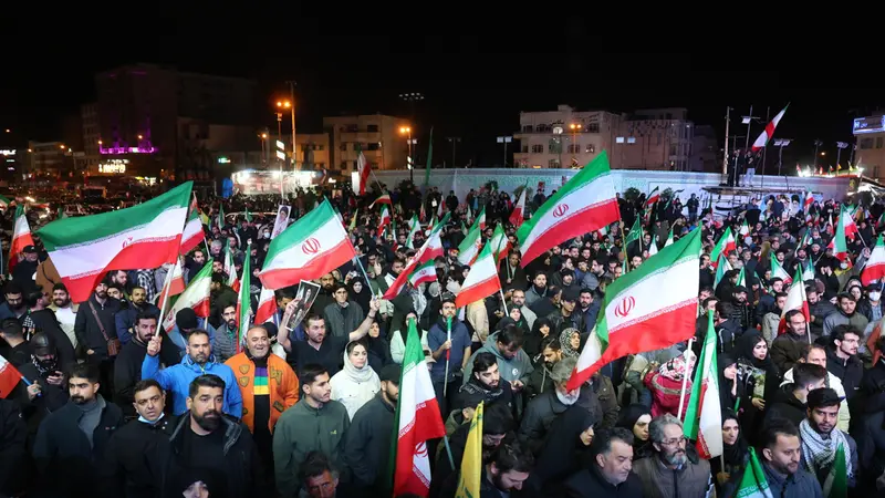 epa12874355 Iranians wave flags during a demonstration following the announcement of a two-week ceasefire at Enghelab Square in Tehran, Iran, 08 April 2026. Iran and the USA agreed to the two-week truce to halt military operations and keep the Strait of Hormuz open for oil and gas shipments, with formal peace talks set to begin in Islamabad on 10 April. EPA/ABEDIN TAHERKENAREH