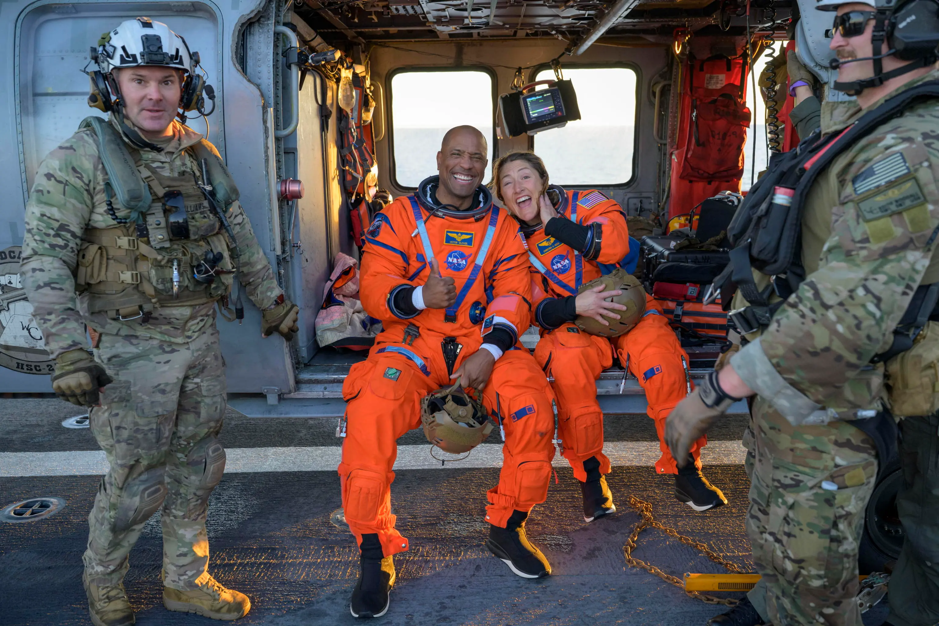 epa12882005 A handout photo made available by the National Aeronautics and Space Administration (NASA) shows NASA astronaut Victor Glover (L), Artemis II pilot, and NASA astronaut Christina Koch, Artemis II mission specialist are seen sitting on a Navy MH-60 Seahawk from Helicopter Sea Combat Squadron (HSC) 23 on the flight deck of USS John P. Murtha after they and fellow crewmates CSA (Canadian Space Agency) astronaut Jeremy Hansen, Artemis II mission specialist, and NASA astronaut Reid Wiseman, Artemis II commander, were extracted from their Orion spacecraft after splashdown, in the Pacific Ocean off the coast of California, 10 April 2026. NASA’s Artemis II mission took the quartet on a nearly 10-day journey around the Moon and back to Earth. Following a splashdown at 5:07 p.m. PDT (8:07 p.m. EDT), NASA, U.S. Navy, and U.S. Air Force teams worked to bring the Orion spacecraft aboard the recovery ship. EPA/BILL INGALLS / NASA / HANDOUT MANDATORY CREDIT: (NASA/Bill Ingalls) AFS 8/101 - PermanentHANDOUT EDITORIAL USE ONLY/NO SALES