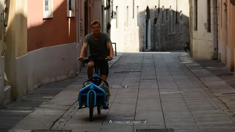 Ernst Johannes Prosman in bicicletta in via Musei a Brescia