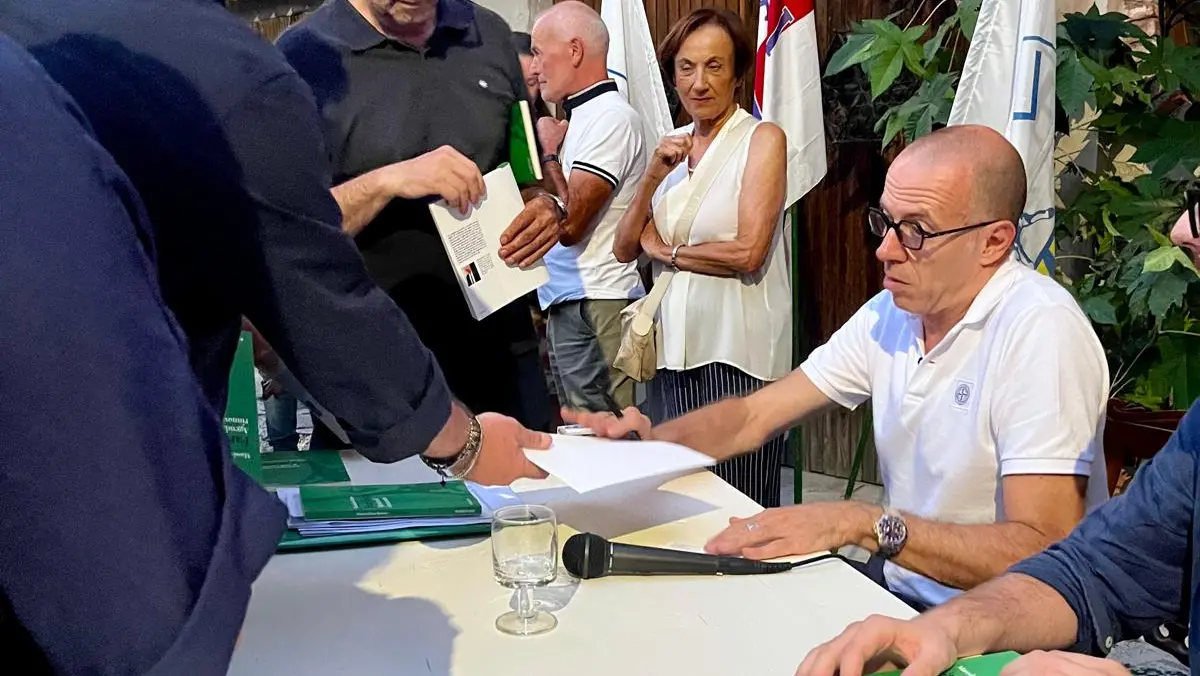 Massimiliano Romeo mentre firma copie del suo libro - © www.giornaledibrescia.it